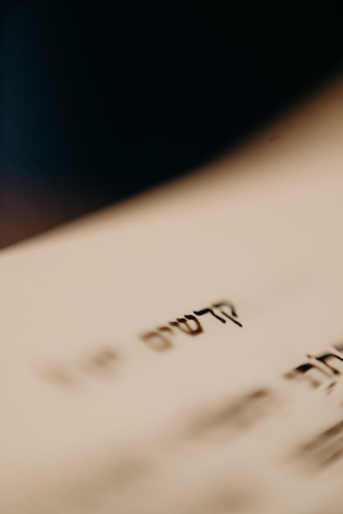 Detailed close-up of Hebrew text on a book page, evoking tradition and religious study.